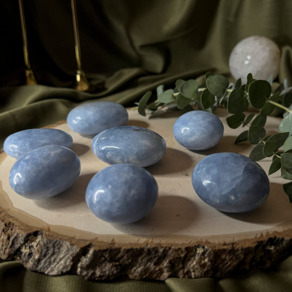 Blue Calcite palm stones of various sizes.
