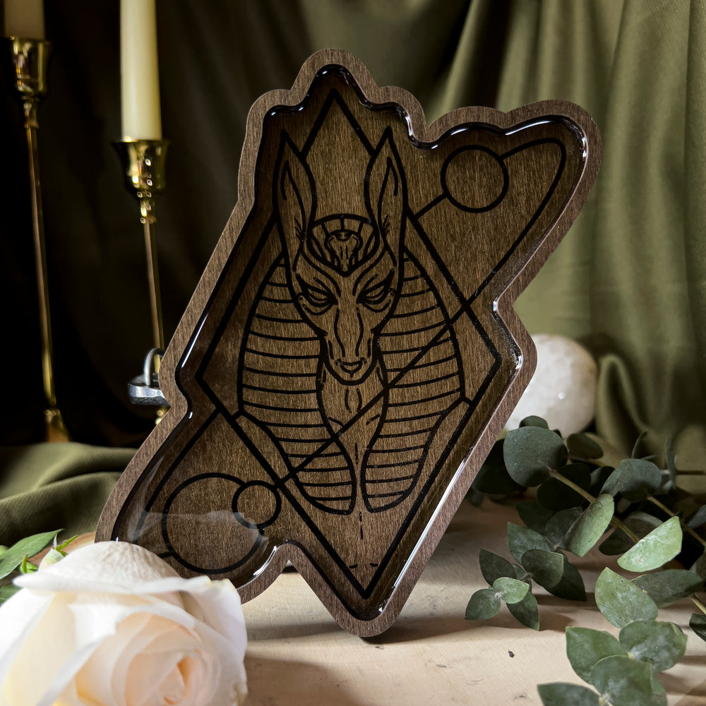 A wood offering tray depicting Anubis.