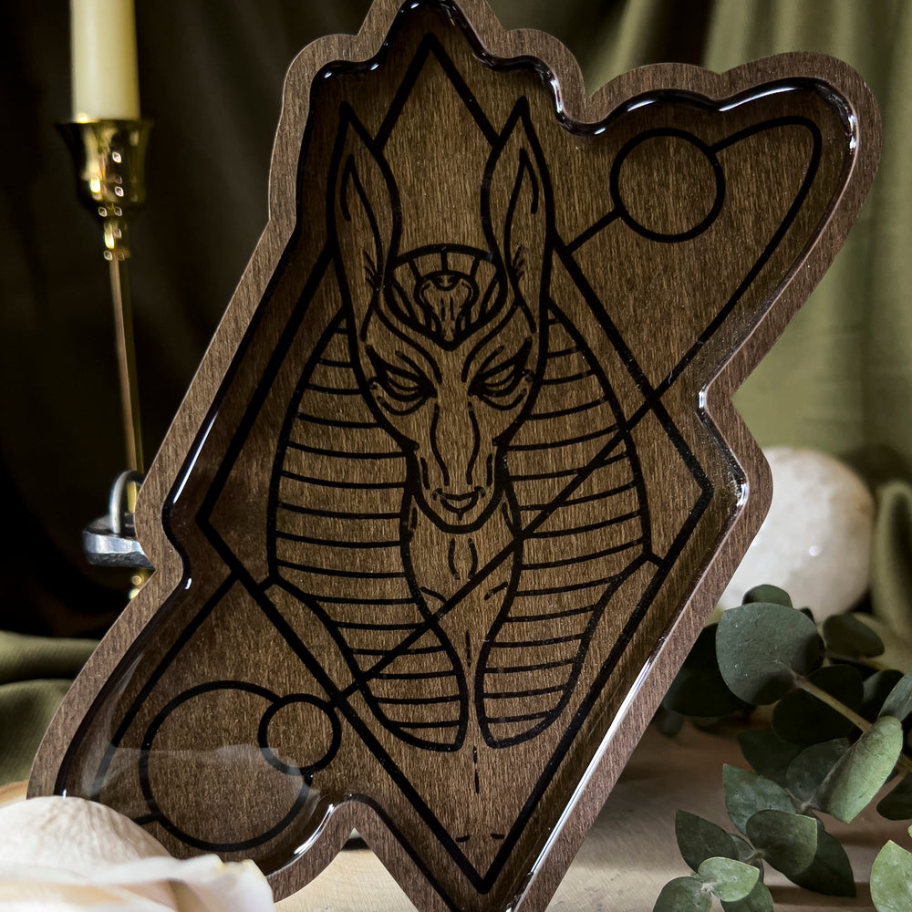 A wood offering tray depicting Anubis, closeup.