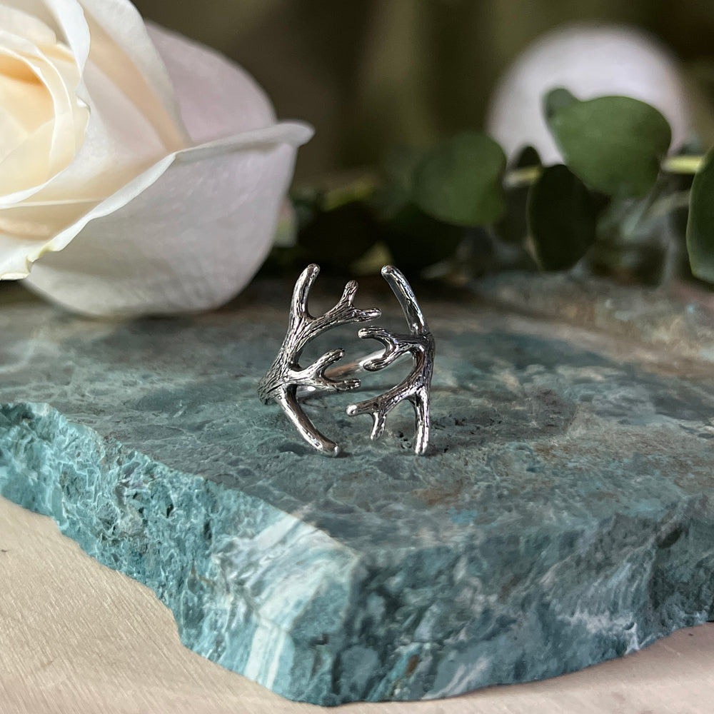 Adjustable silver ring depicting antlers wrapping around your finger.