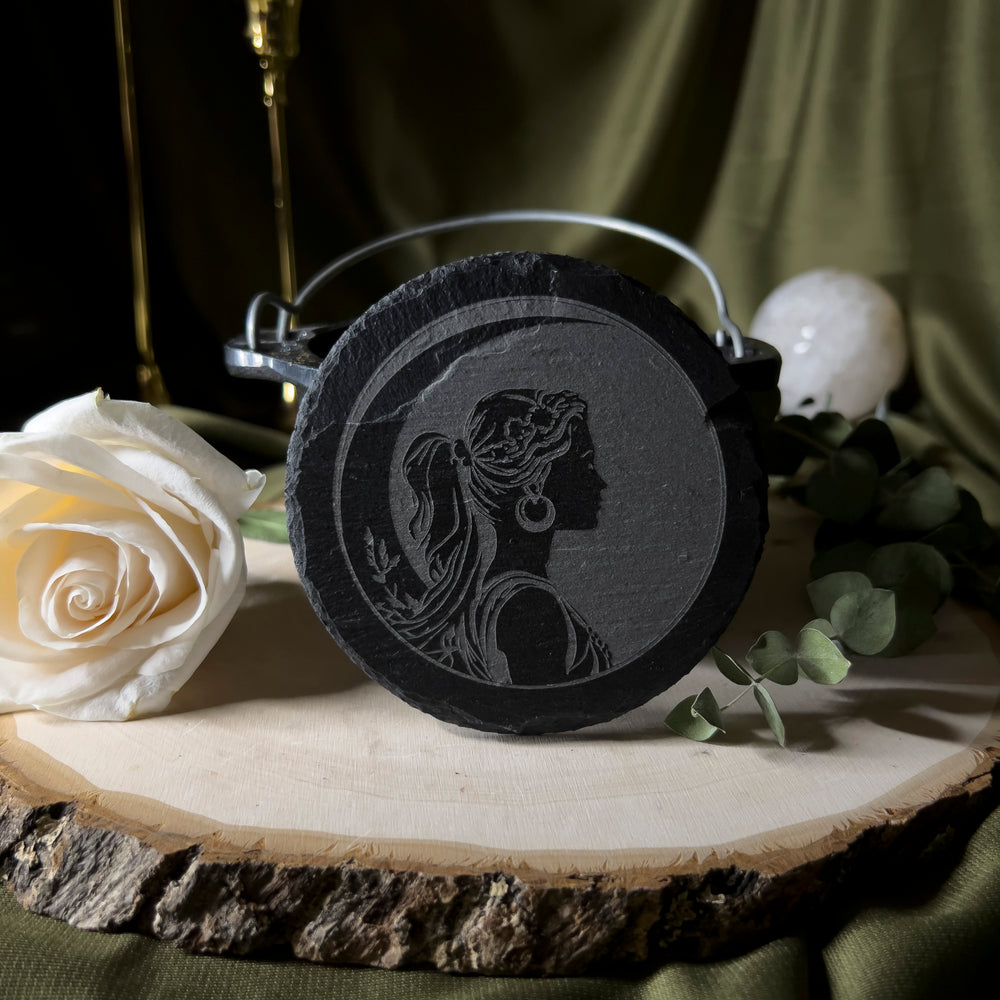 Round slate tile with a carved depiction of Artemis.