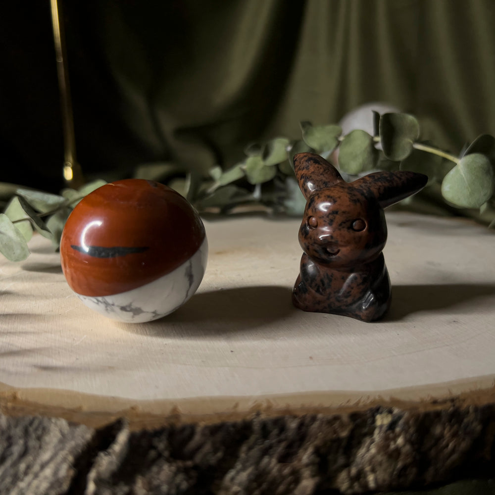 Mahogany obsidian pikachu with a howlite and red jasper pokeball.