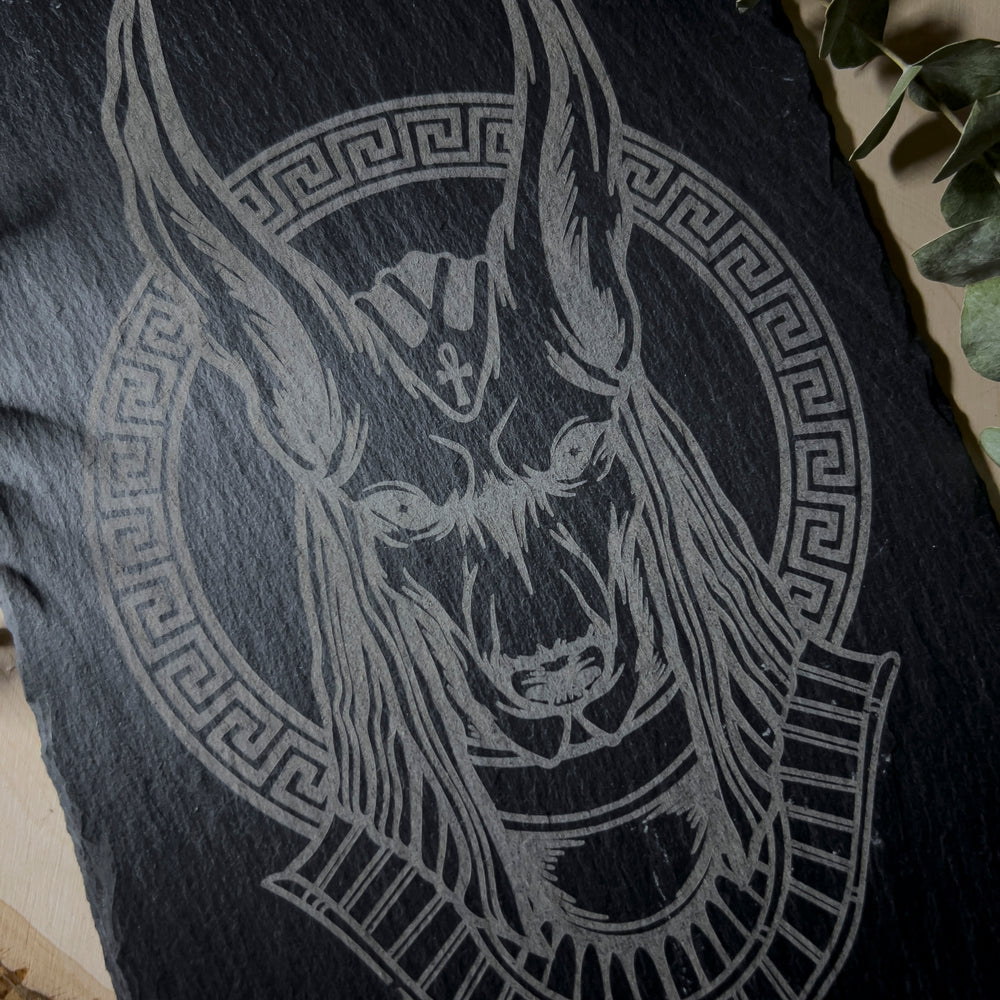 Slate wall art depicting the god Anubis.