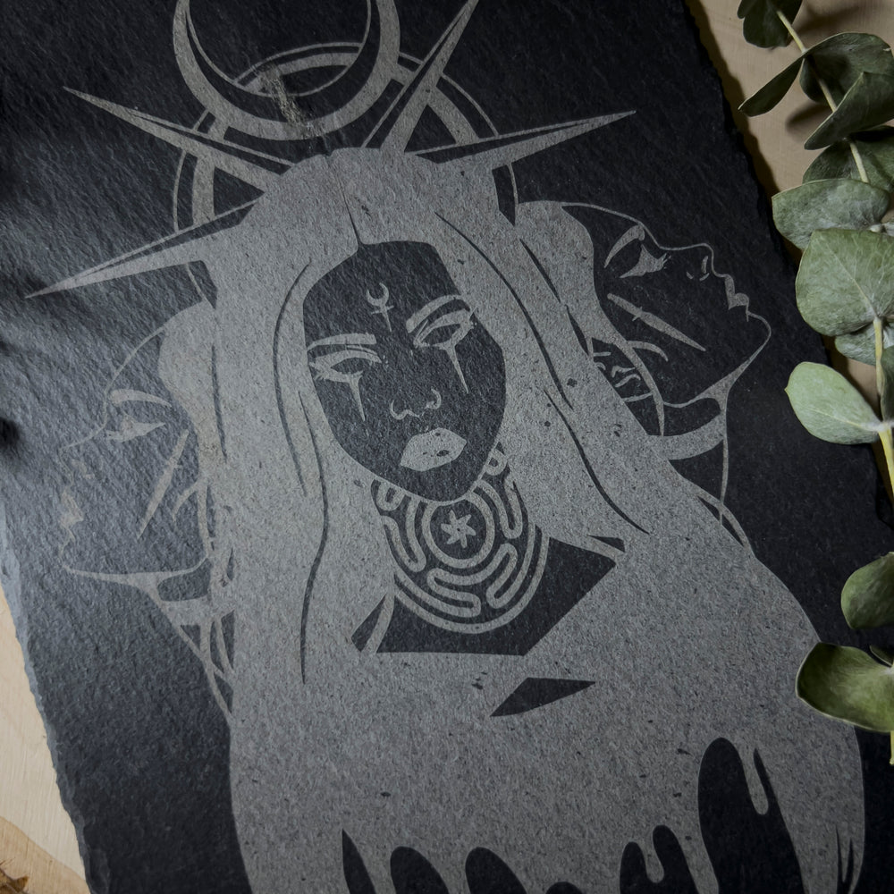 Slate wall art depicting Hekate and her three faces representing the crossroads.