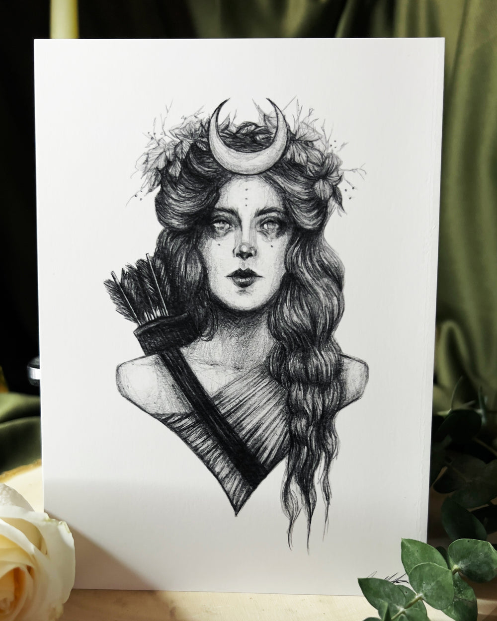 Art print depicting the goddess Artemis with florals and a moon in her hair and her bows on her back.